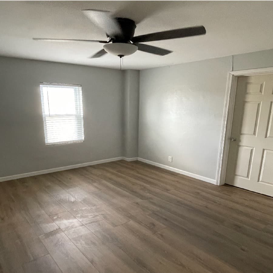 Bedroom after new vinyl plank flooring and paint.