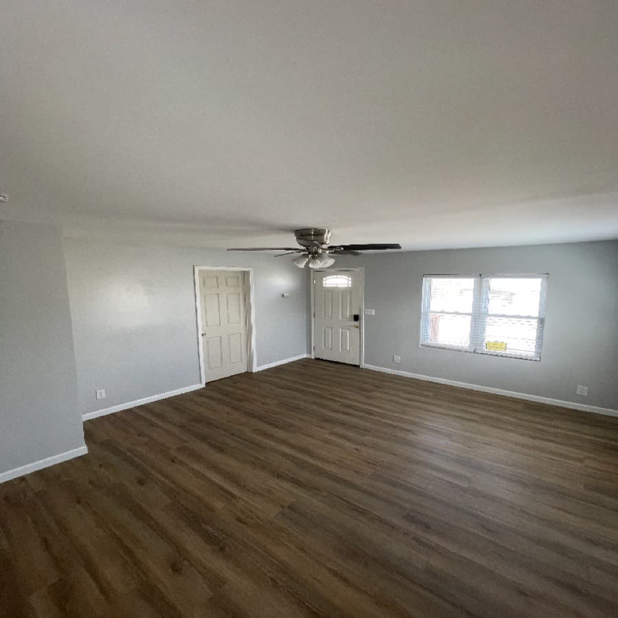 Living room after renovation, with new flooring and paint.